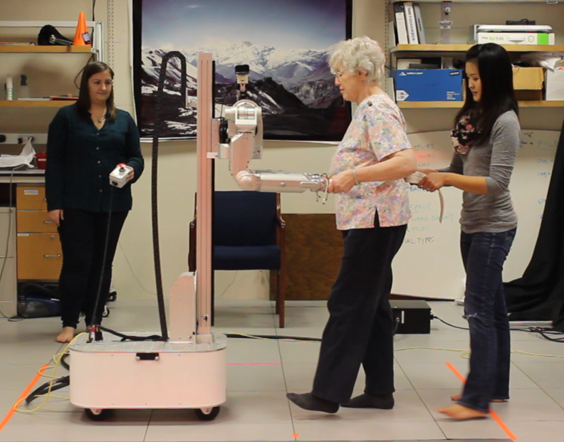 A person partner dances with the robot DARCI.
